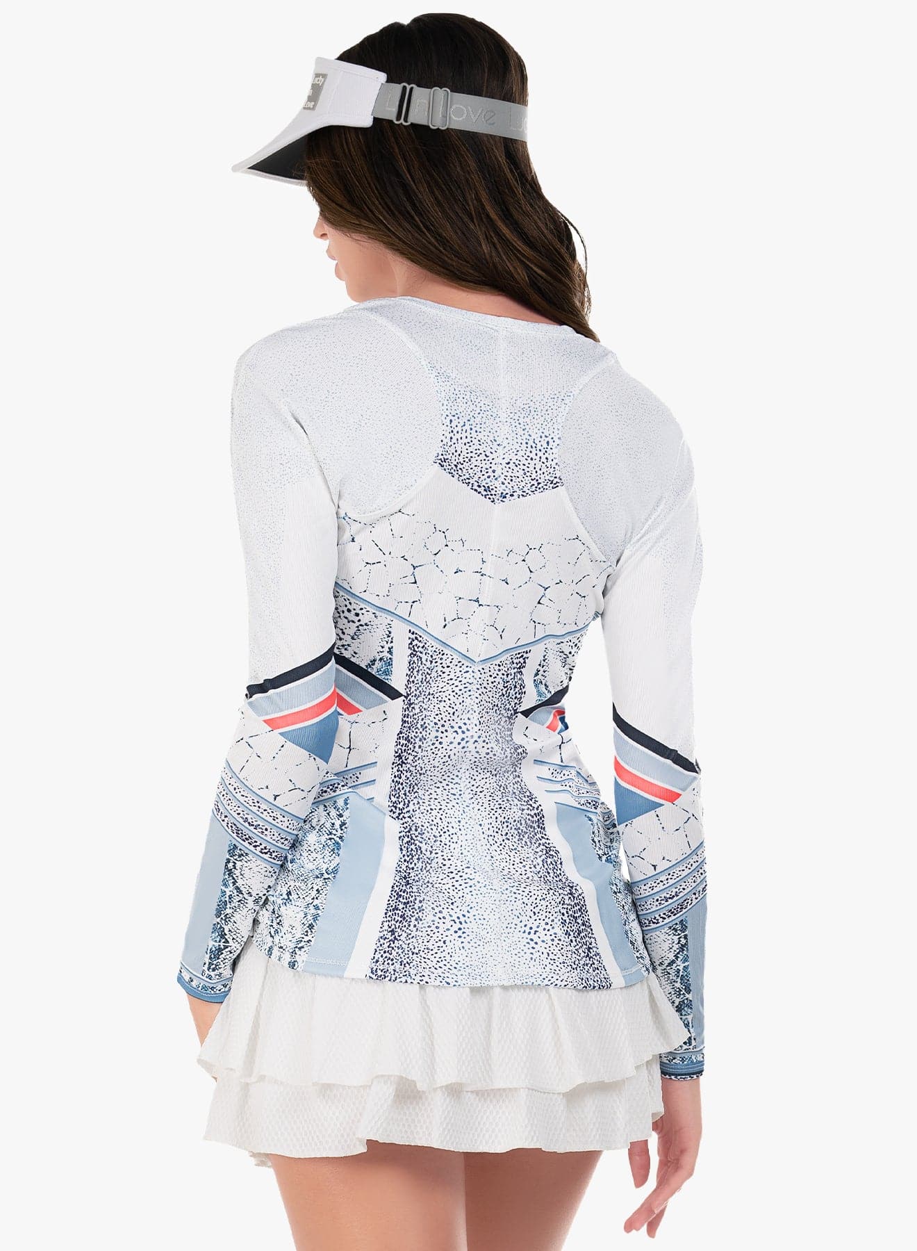 Back view if model wearing a long sleeve with a snake print pattern in shades of navy and blue, paired with a white visor.