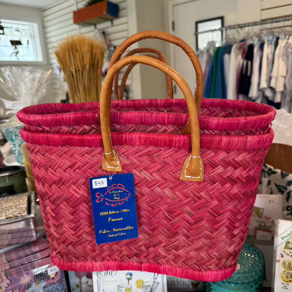 Pink woven beach bag with leather brown handles