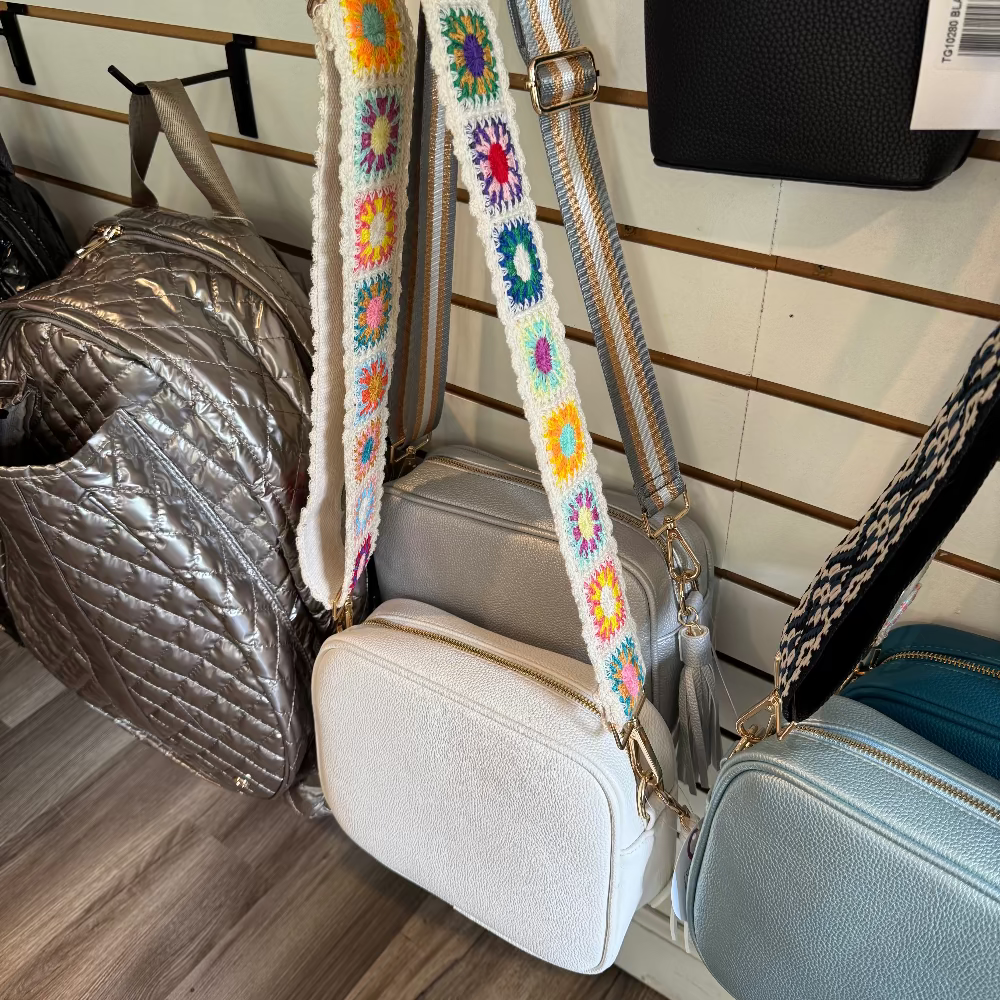 White handbag with crocheted flower strap.