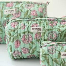 A medium sized mint green with pink floral patterned travel makeup organizer with the brand label 'MYNAH' on the front.