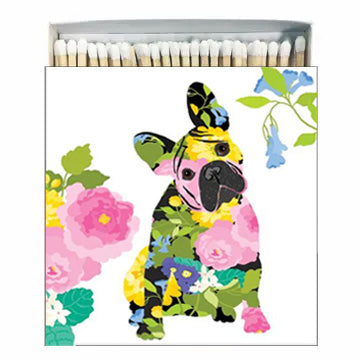 A box of square matches with a colorful floral design featuring a dog's face in the center.