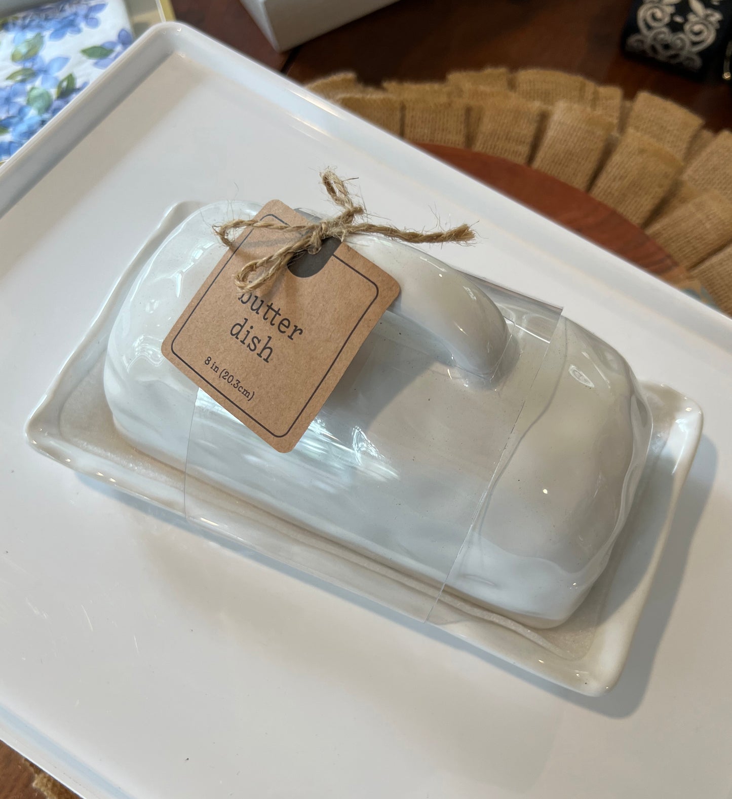 A white porcelain butter dish with a lid, tied with a string and labeled 'Winter Dish'.