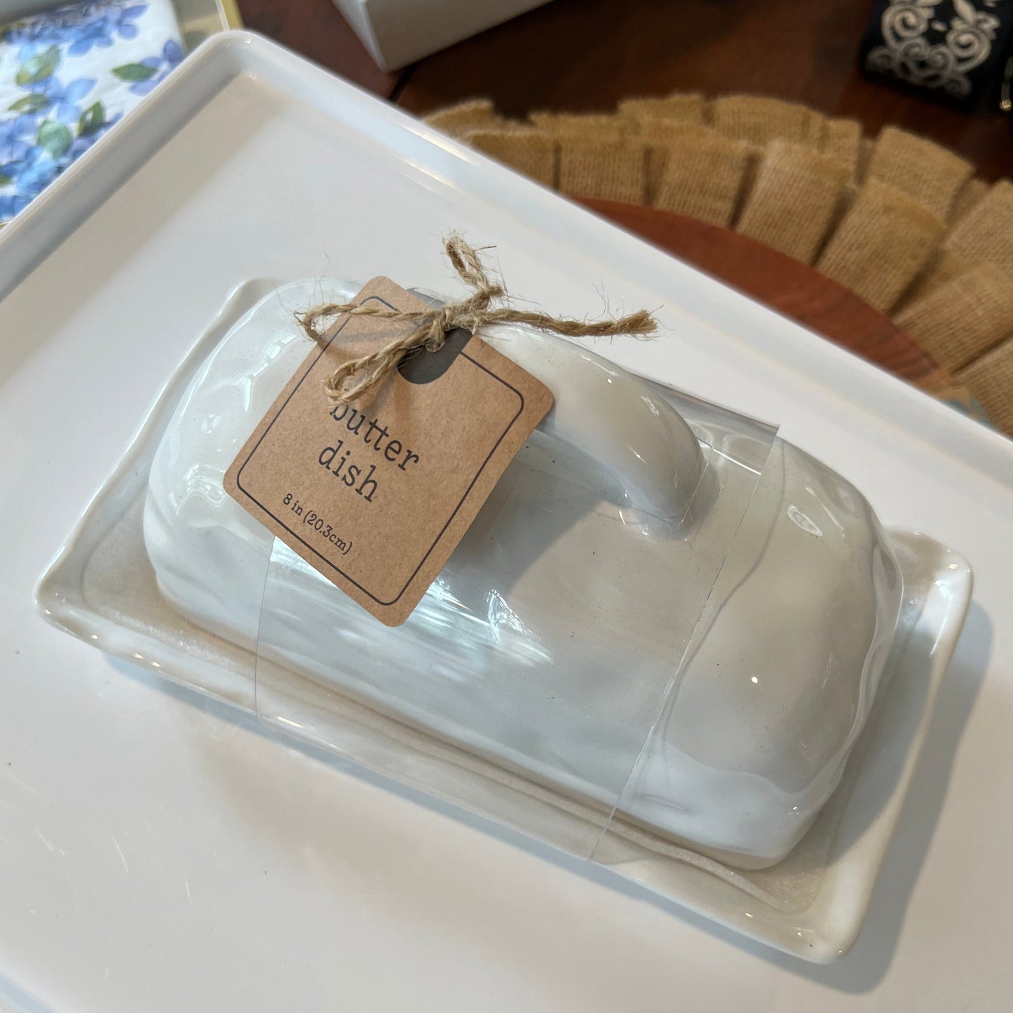 A white porcelain butter dish with a lid, tied with a string and labeled 'Winter Dish'.