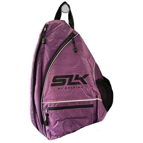 A purple Selkirk pickleball paddle sling bag with black and white accents, featuring a shoulder strap and multiple compartments.