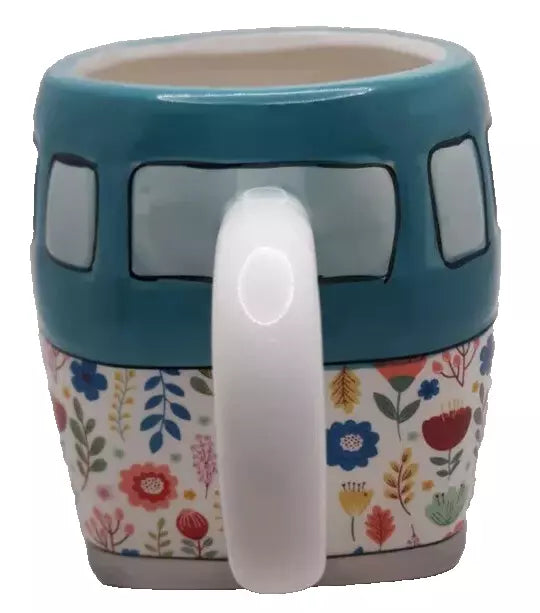 Handle view of an earthenware mug with a floral pattern and camper design, teal and multicolor, floral design