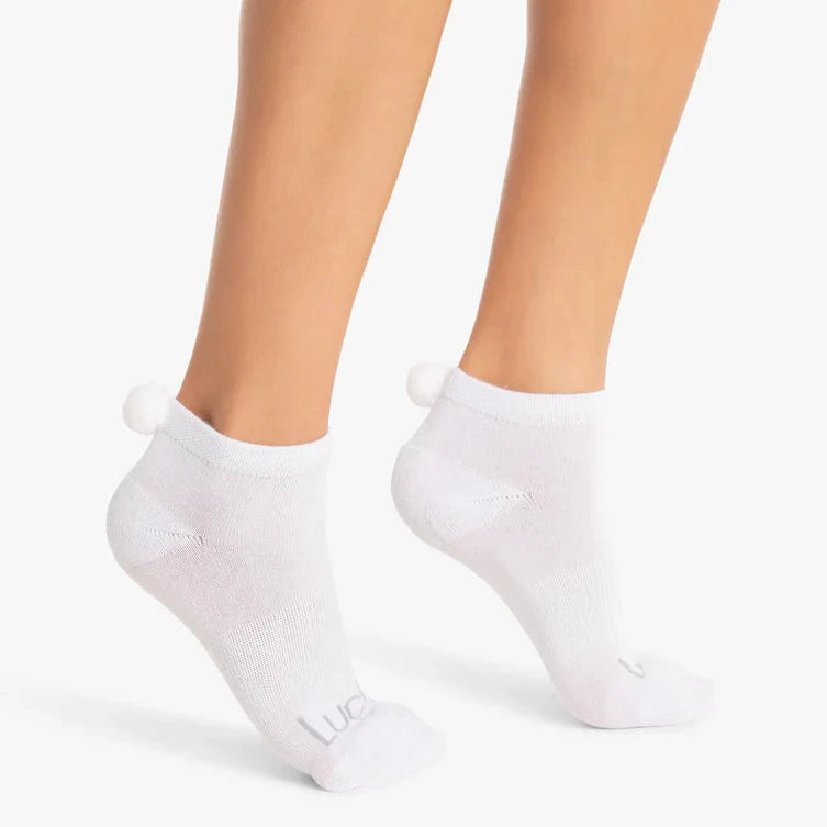 A pair of white low-cut socks with balls
