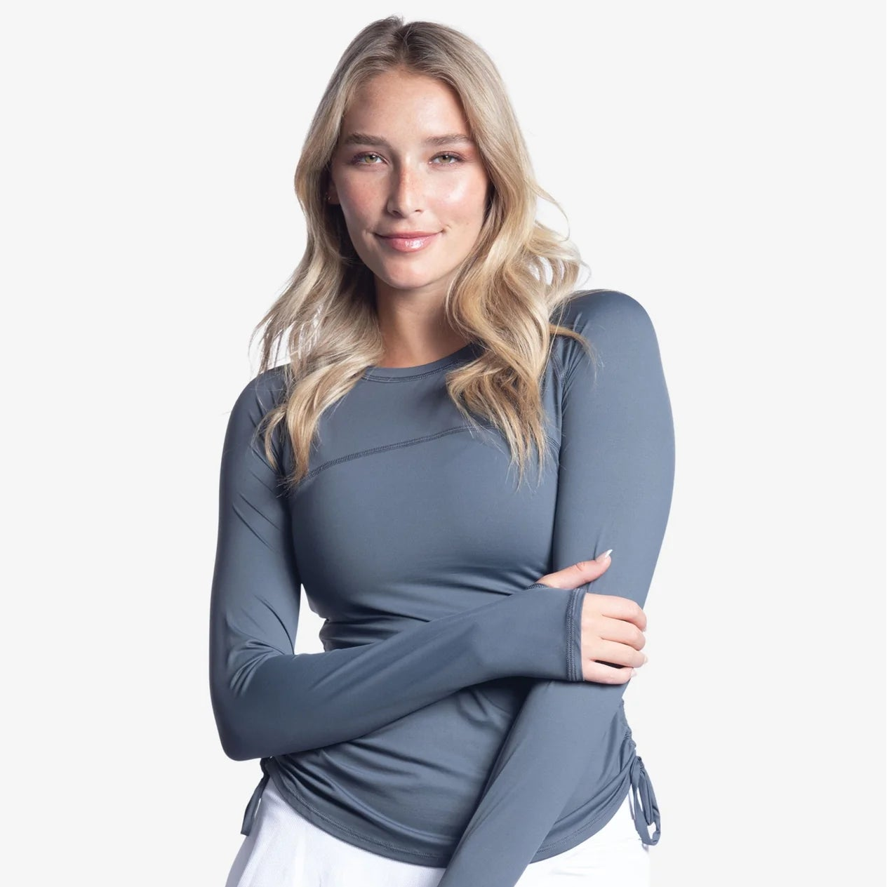 Woman wearing a long-sleeve gray top.