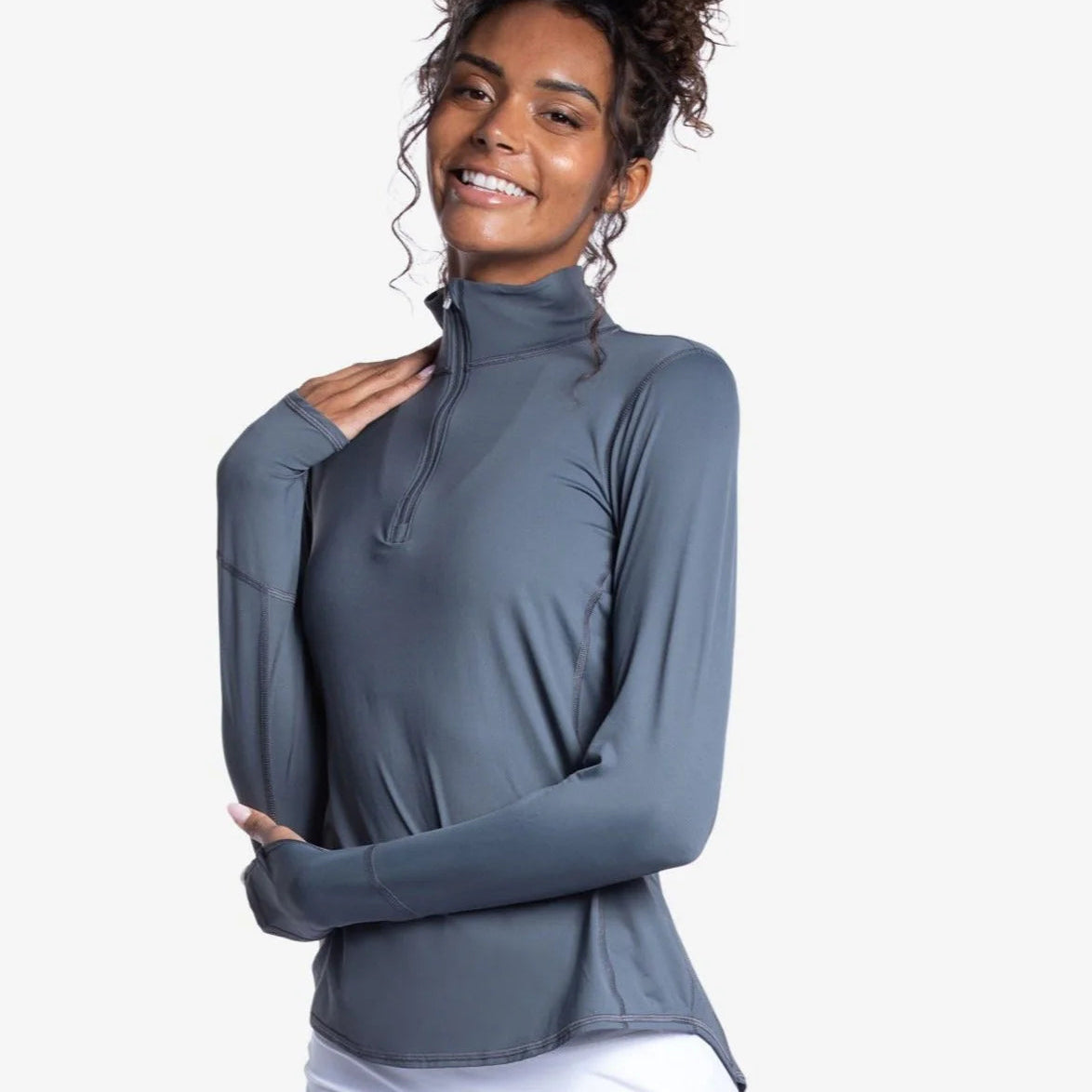 Woman wearing a grey long-sleeve top with a quarter zip, SPF 50 - Front