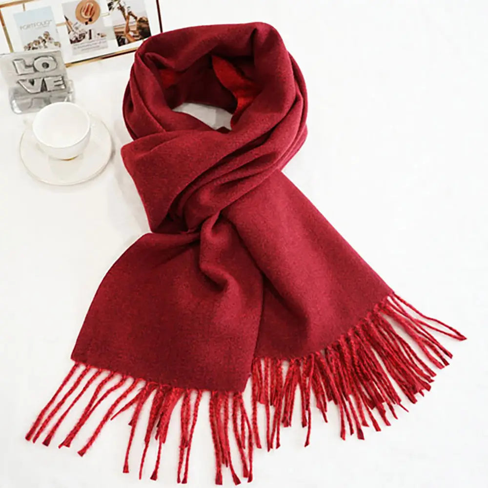Burgundy/red classic soft scarf featuring elegant fringe edges.