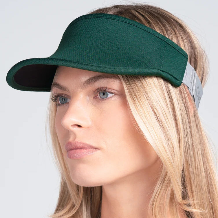 Woman wearing our forest green performance visor. French terry fabric on the inside headband has moisture wicking.