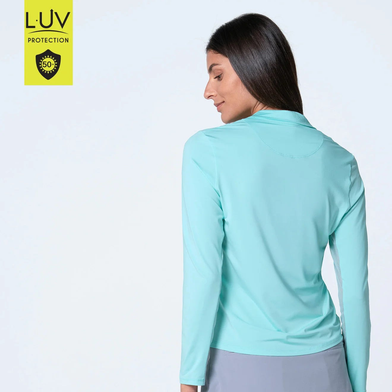 Back view of lightweight SPF 50 sun protection top that keeps you cool and protected from the sun. This zip mock neck top is done in our signature  and features mesh inserts along the sleeves for added breathability and fashion flair.