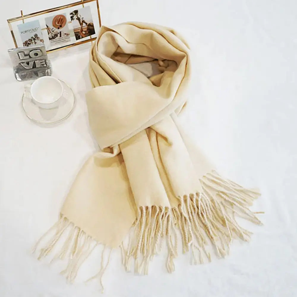Cream/white classic soft scarf featuring elegant fringe edges.