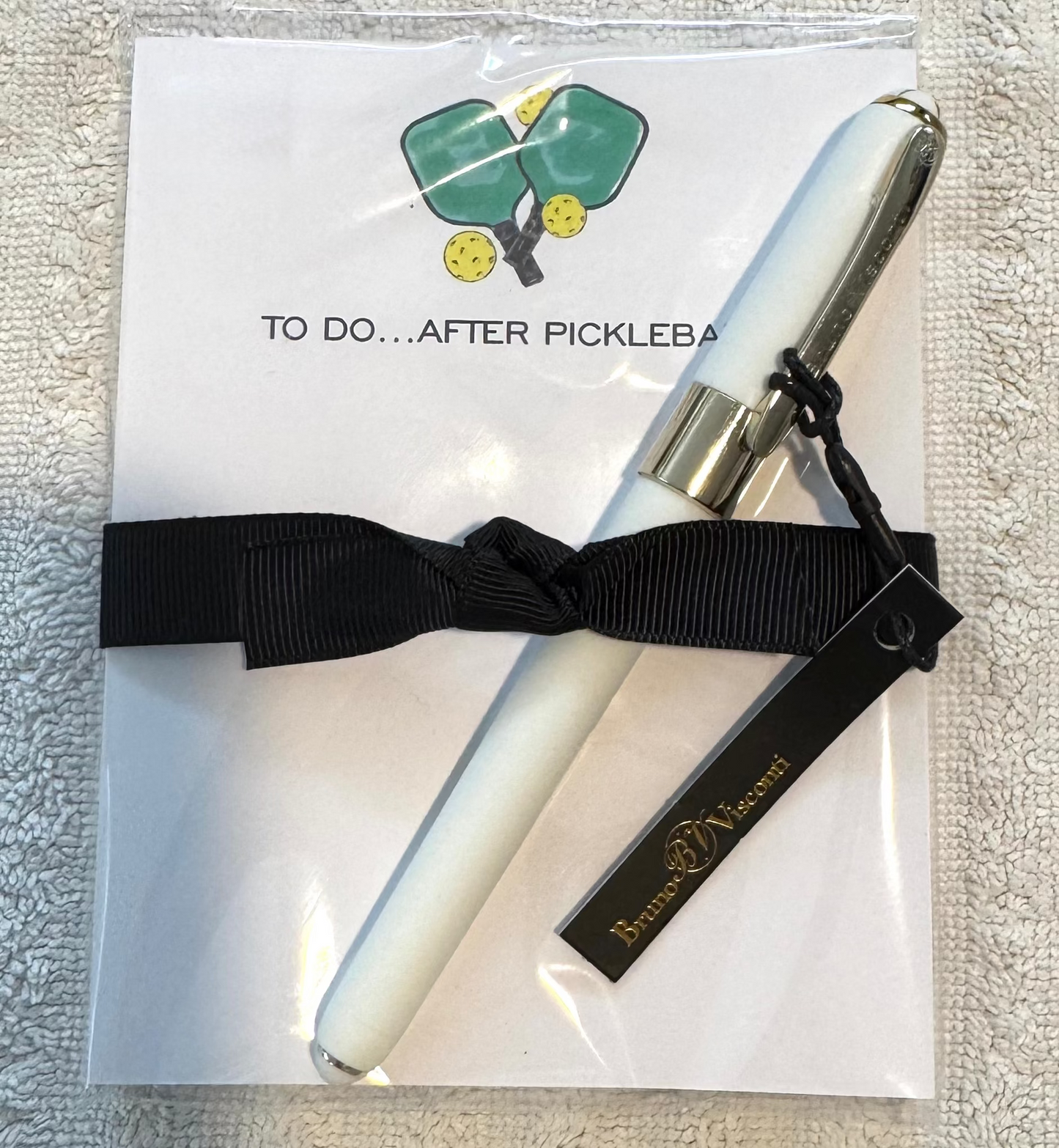 To Do After Pickleball notepad gift tied with black ribbon and comes with a white ballpoint pen by Bruno Visconti
