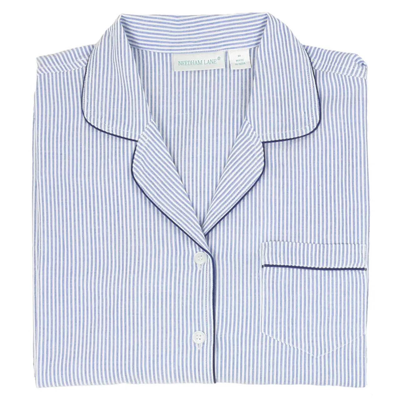Folded long sleeve top of Women"s Navy and white seersucker striped pajama set