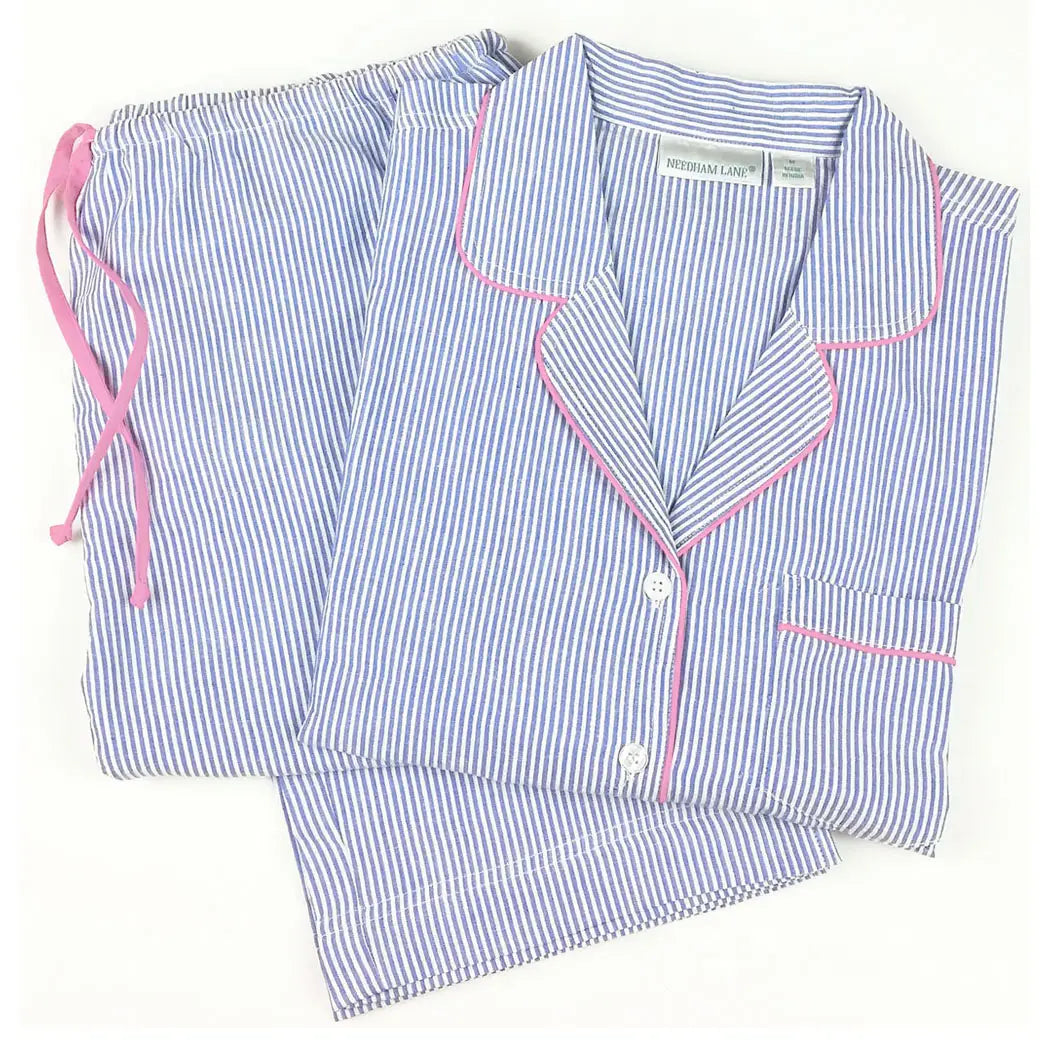 Women's blue and white striped pajama set with pink piping