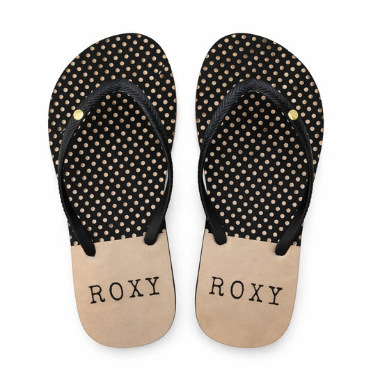 Pair of black and beige polka dot flip-flops with 'ROXY' branding on a white background