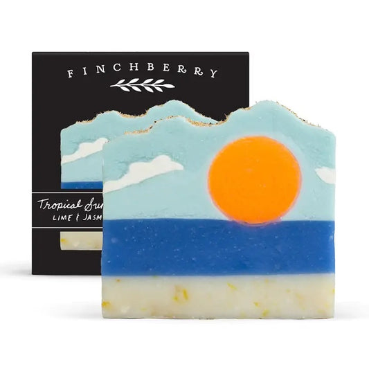Soap bar with mountain and sun design in front of a black 'Finchberry' packaging