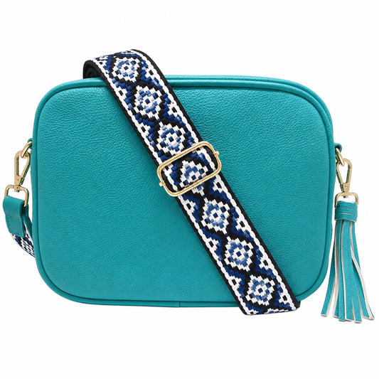 Caribbean blue camera bag with clipped decorative tassel and zip closure with geometric strap with gold hardware.