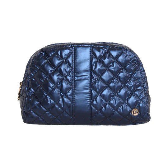 A quilted saphire blue cosmetic bag with a zipper top, made by Lemonbella