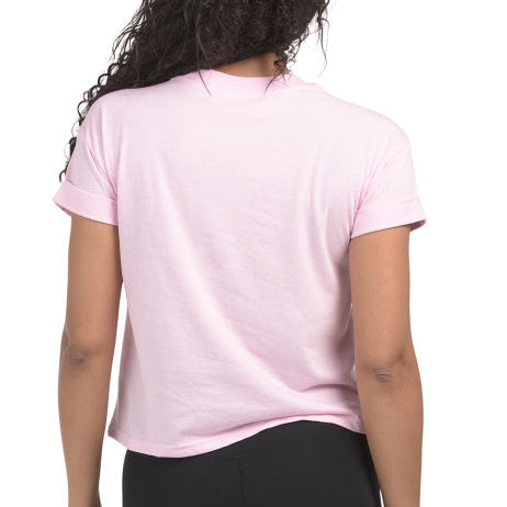 Back of woman wearing a pink t-shirt with a Snoopy pickleball-themed design