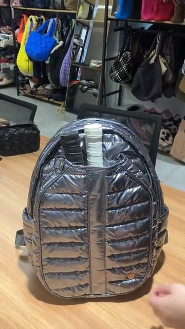Video showing Quilted nylon backpack with specialized pickleball paddle storage 
