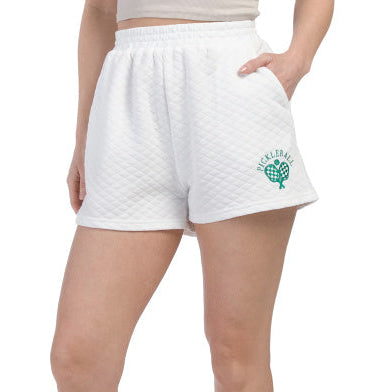 Woman wearing white shorts with a pickleball embroidered logo