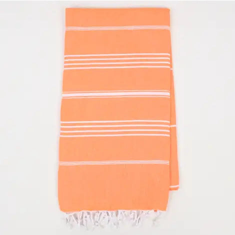 Orange turkish towel with white stripes on a white background.