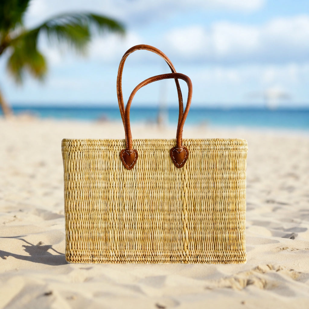 woven bag with long leather handles on the beach